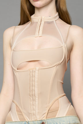 beige contour body by NAMILIA featuring a sculpted fit, corset-style waist with hook-and-eye closure, and high neckline. Statement bodywear.