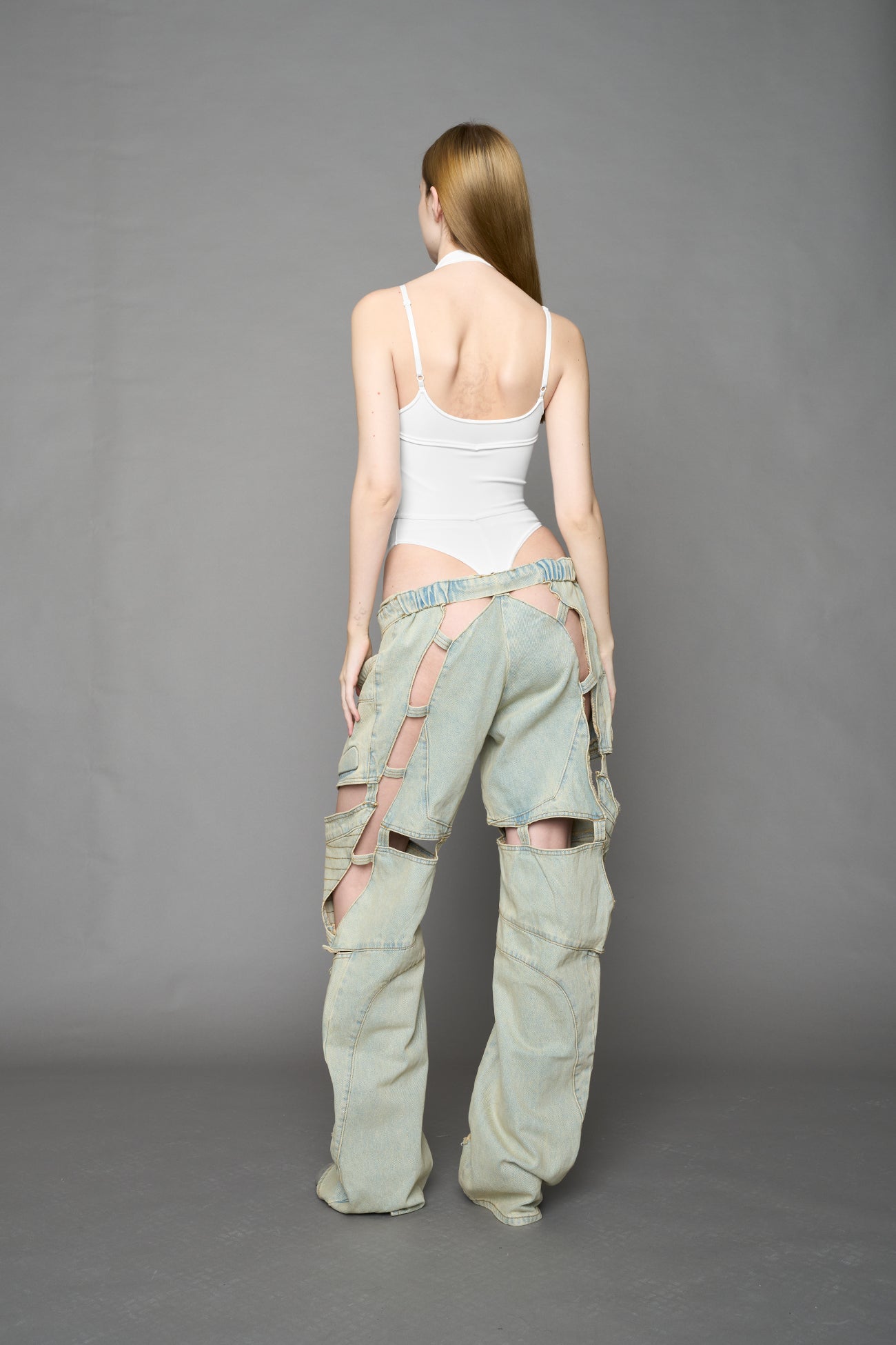 white contour body by NAMILIA featuring a sculpted fit, corset-style waist with hook-and-eye closure, and high neckline. Statement bodywear.