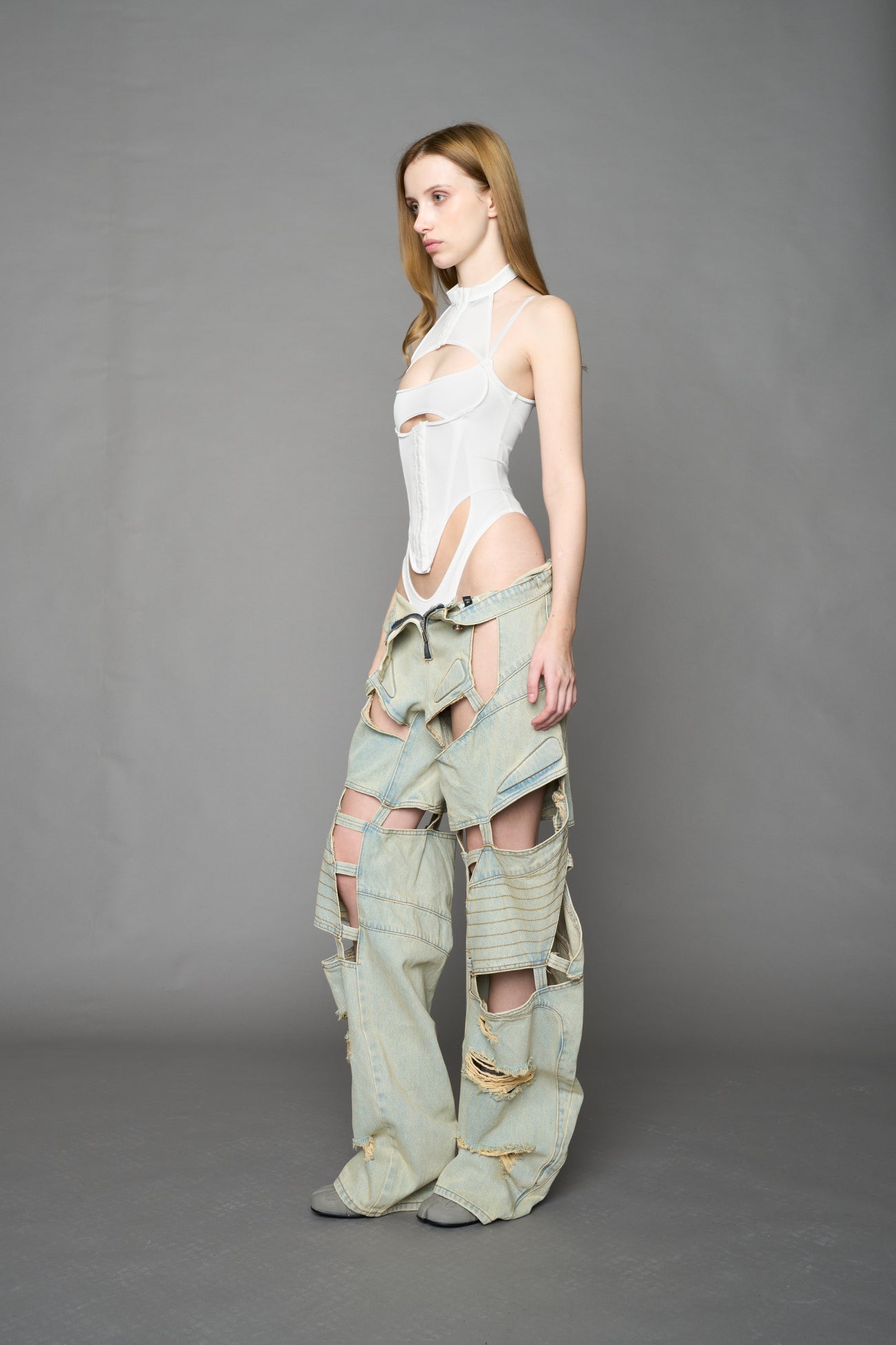 white contour body by NAMILIA featuring a sculpted fit, corset-style waist with hook-and-eye closure, and high neckline. Statement bodywear.