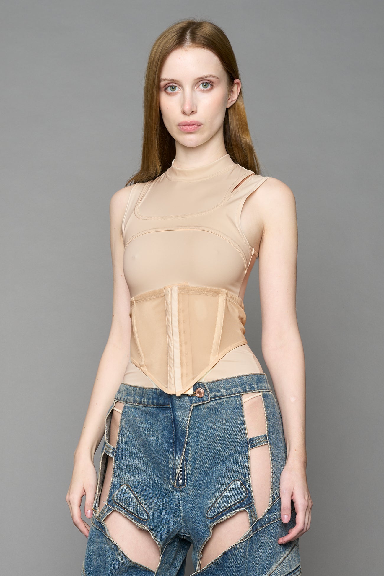 beige contour top by NAMILIA featuring a sculpted fit, corset-style waist with hook-and-eye closure, and high neckline. Statement shaping top.