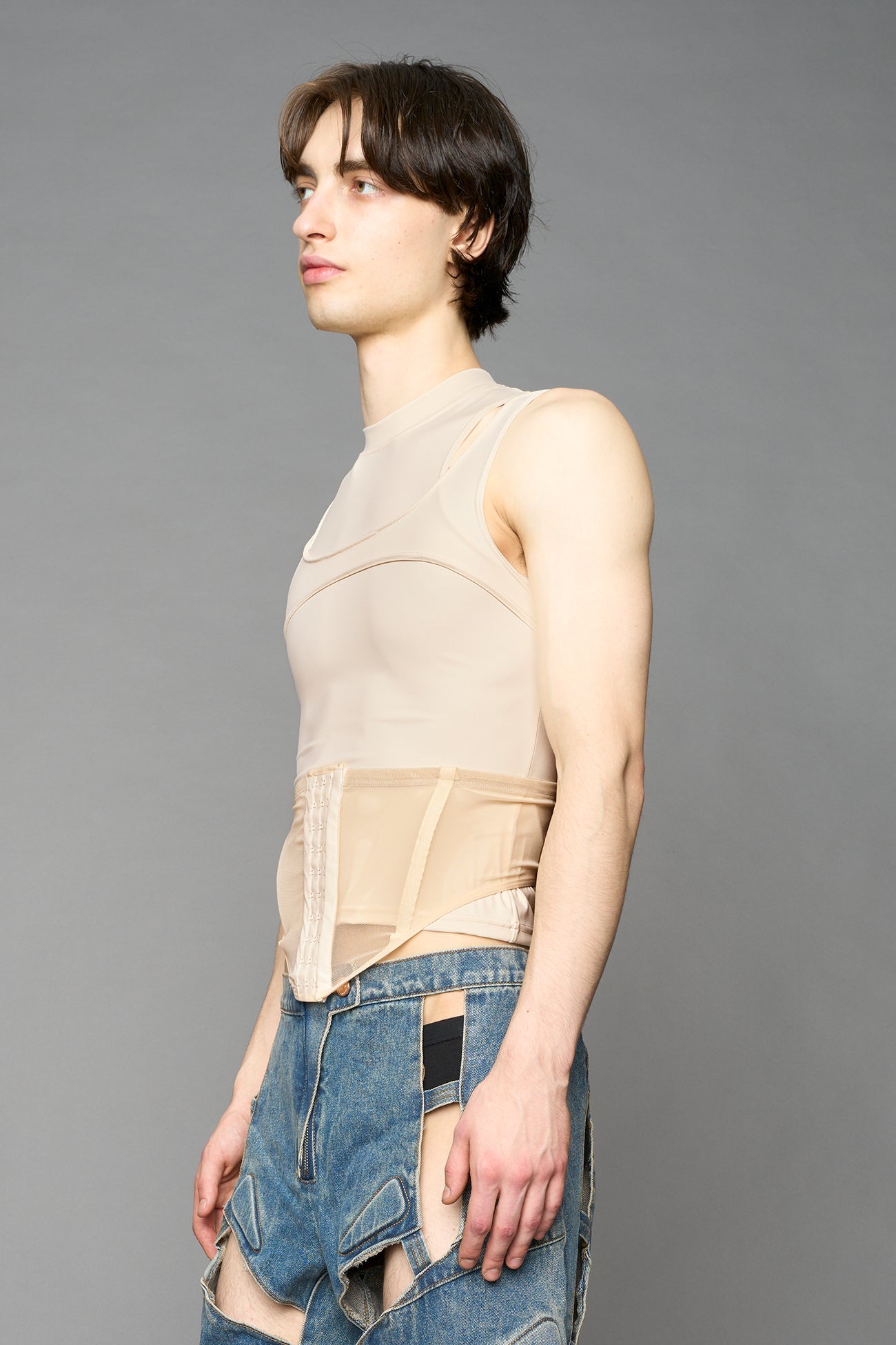 beige contour top by NAMILIA featuring a sculpted fit, corset-style waist with hook-and-eye closure, and high neckline. Statement shaping top.