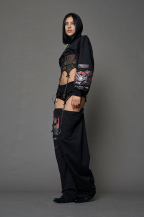 female model wearing a lingerie-inspired black hoodie with a lace corset and a goth-inspired print