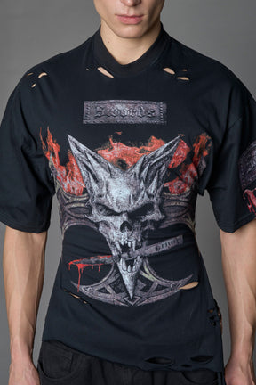 male model wearing a black oversized T-Shirt with a goth-inspired print and a back corset detail