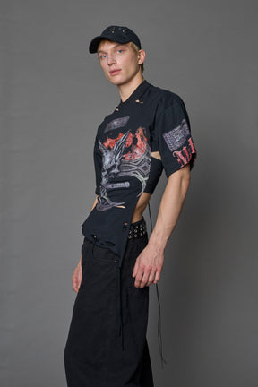 male model wearing a black oversized T-Shirt with a goth-inspired print and a back corset detail