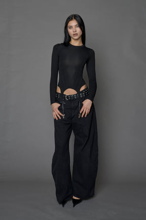 Female model wearing a form fitted lingerie-inspired black longsleeve with garter belt detail