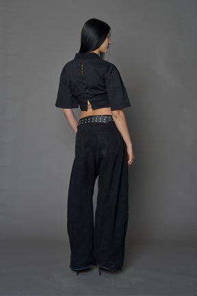 Model wearing a Polo shirt inspired black corset with lacing on the back