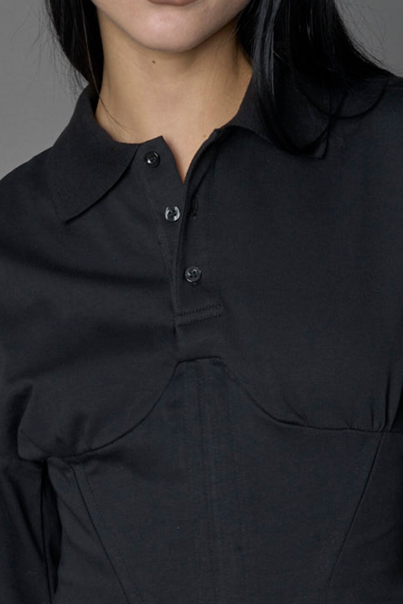 Model wearing a Polo shirt inspired black corset with lacing on the back