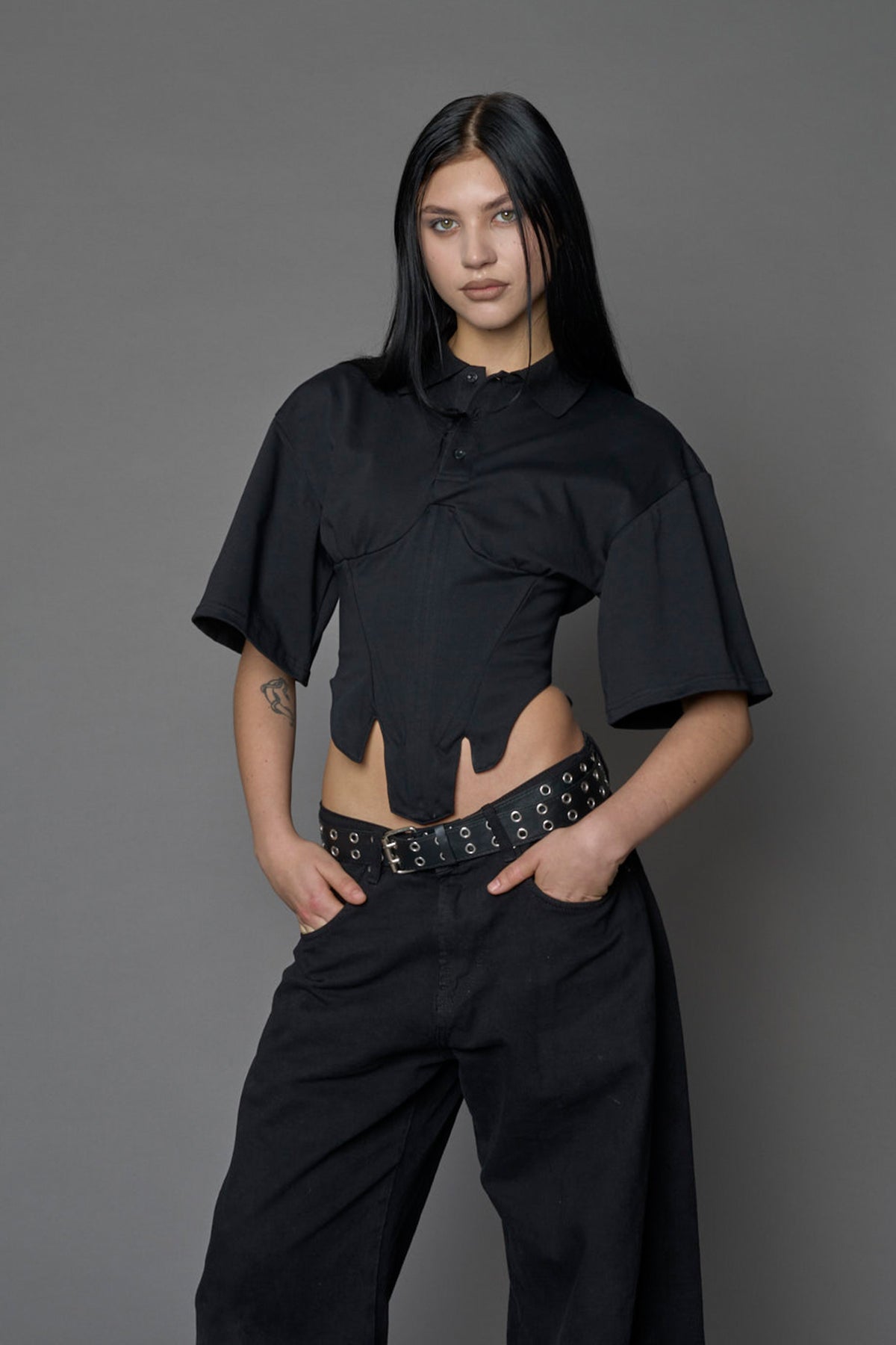 Model wearing a Polo shirt inspired black corset with lacing on the back