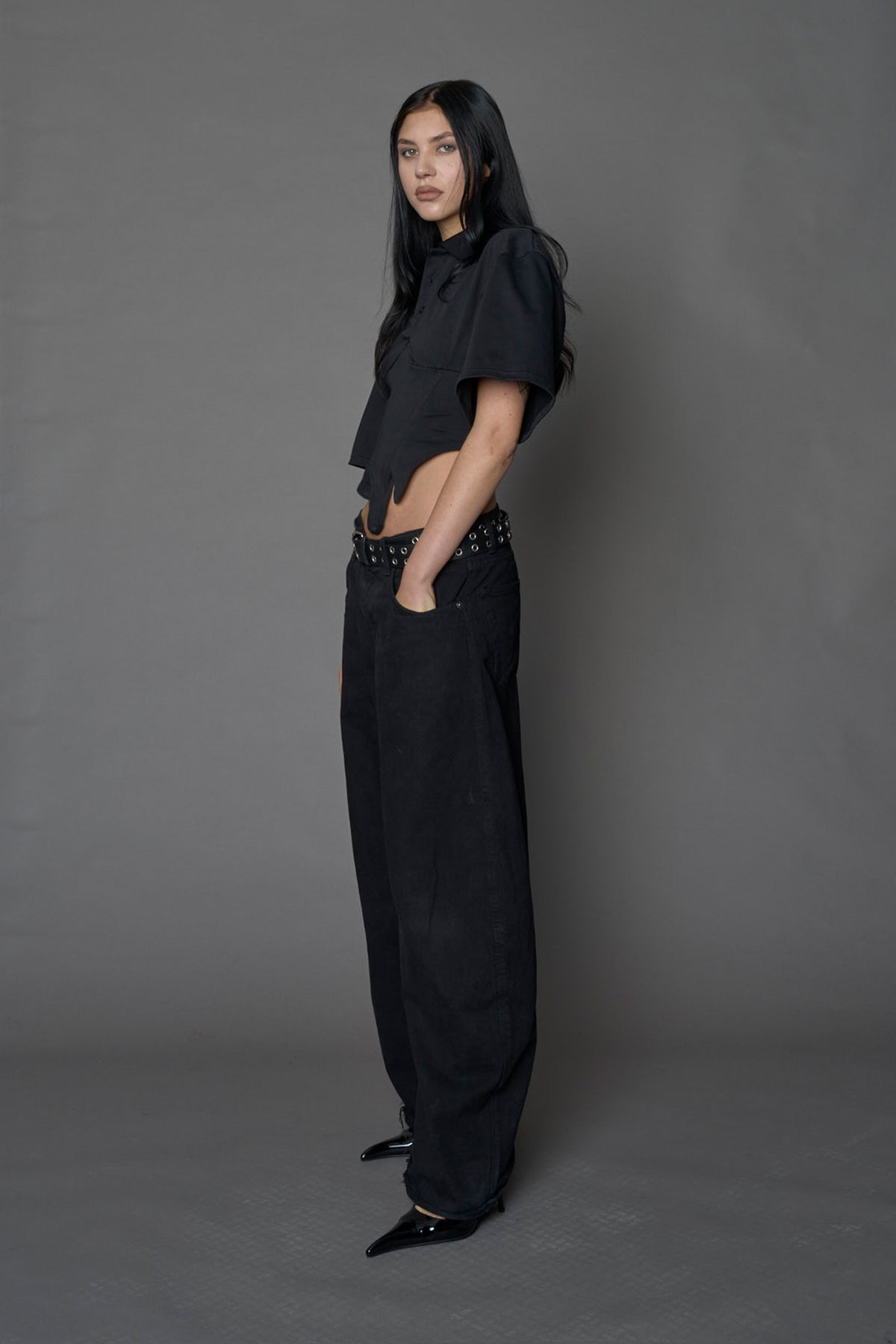 Model wearing a Polo shirt inspired black corset with lacing on the back