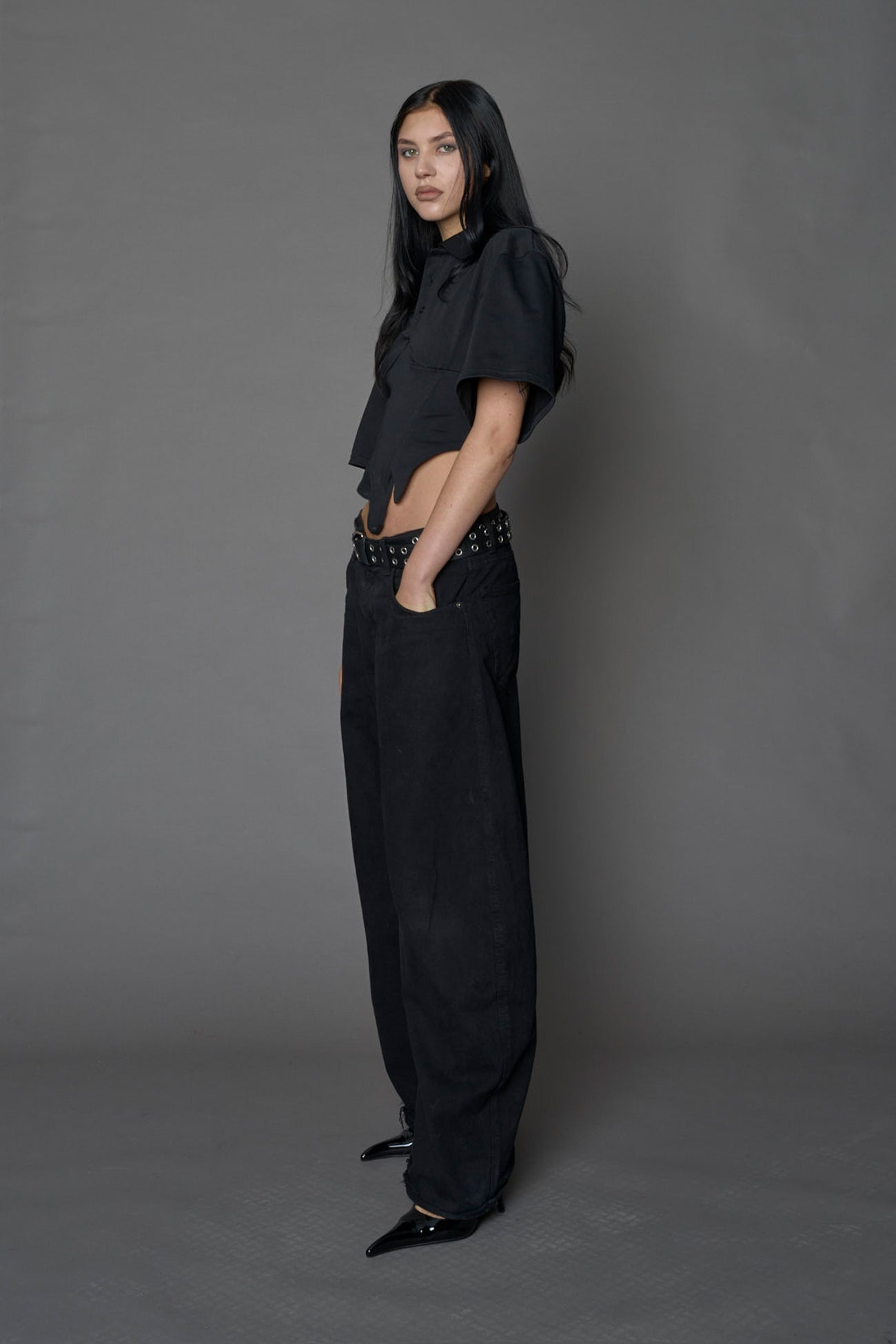 Model wearing a Polo shirt inspired black corset with lacing on the back