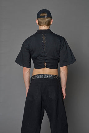 Model wearing a Polo shirt inspired black corset with lacing on the back