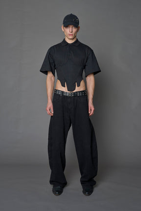 Model wearing a Polo shirt inspired black corset with lacing on the back