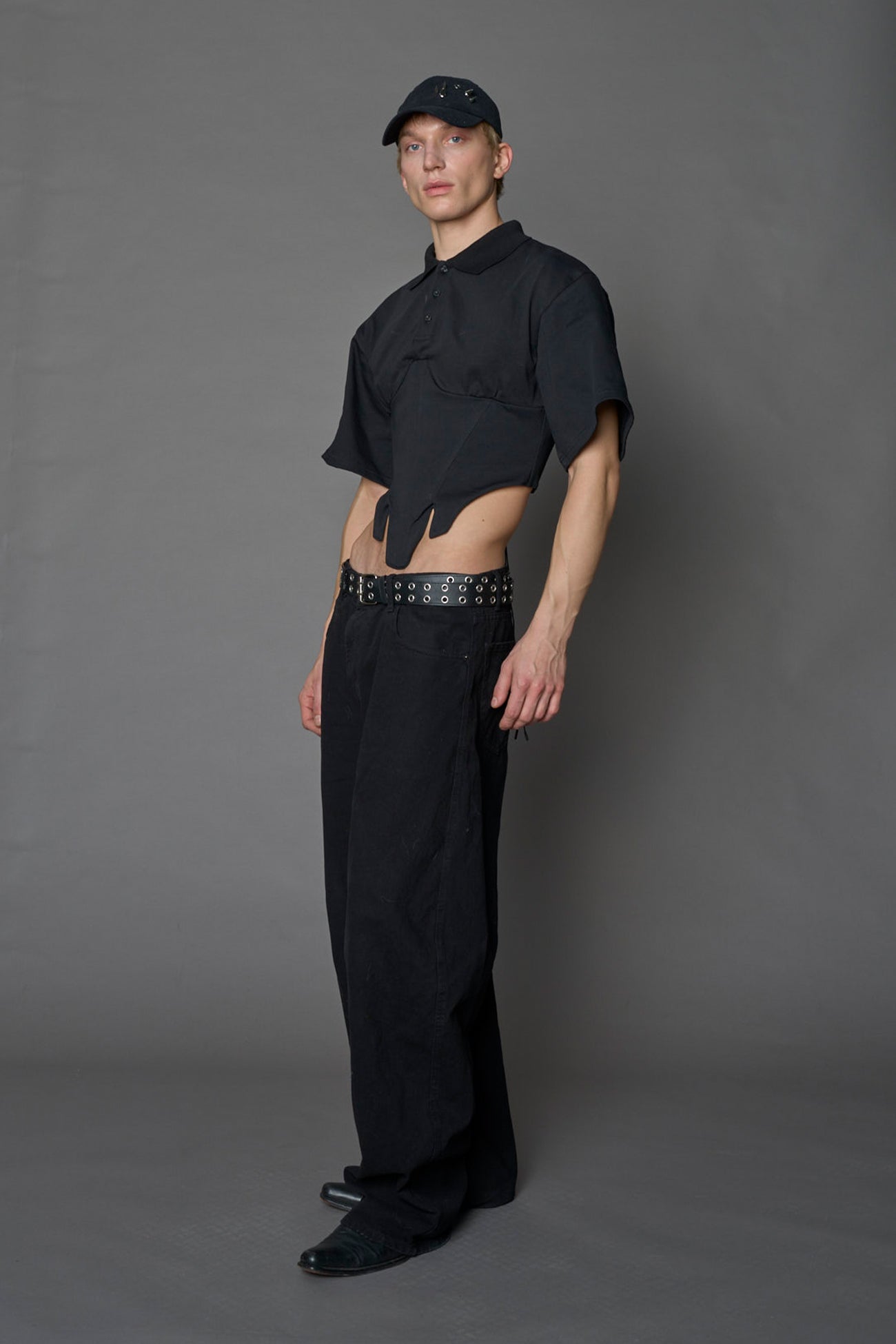 Model wearing a Polo shirt inspired black corset with lacing on the back