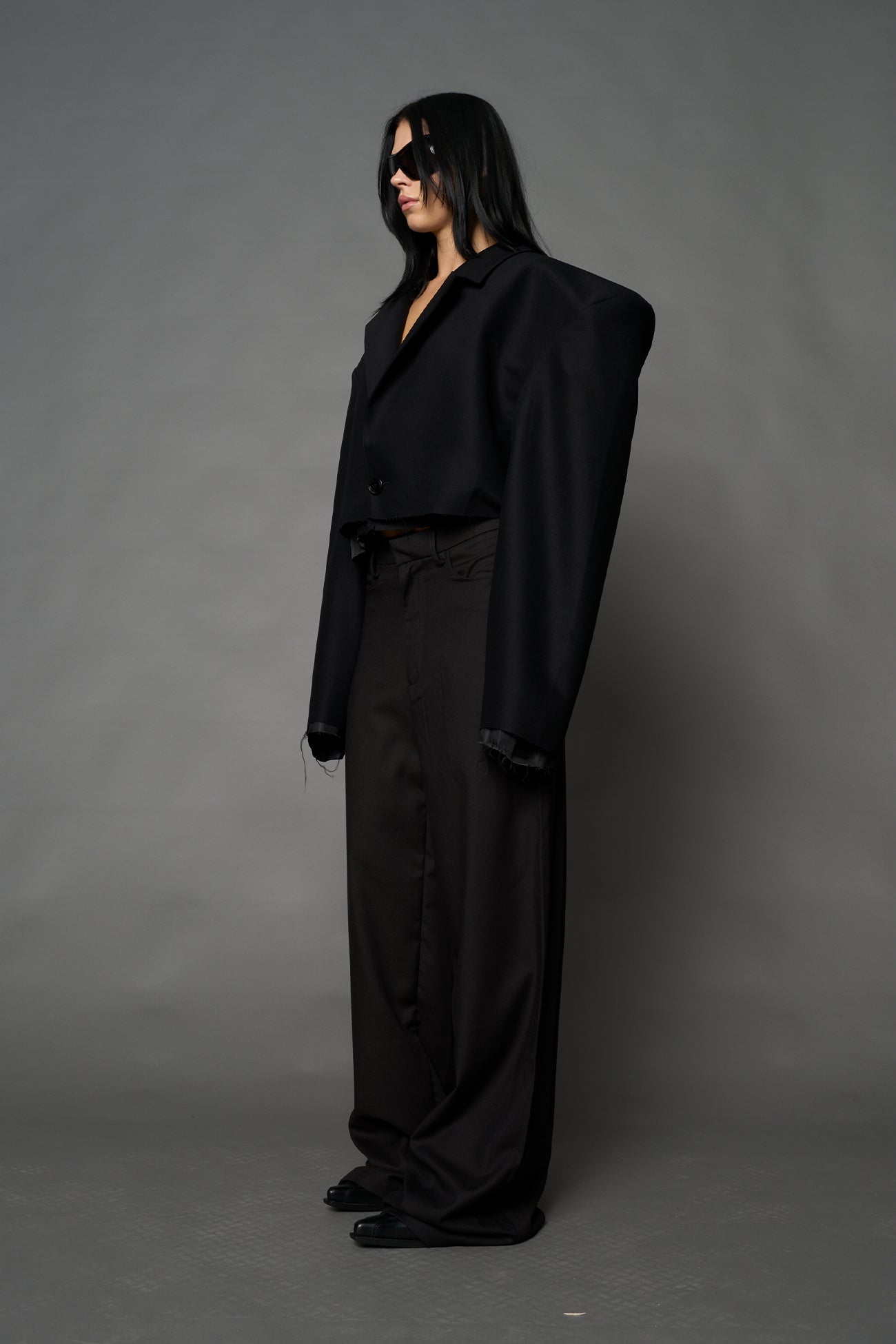Black Namilia cropped blazer with oversized padded shoulders, single button closure and boxy silhouette