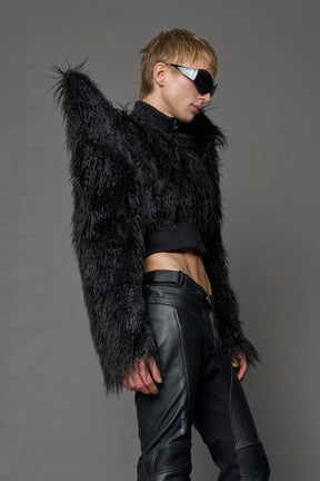 Model wearing black spike shoulder crop faux fur coat