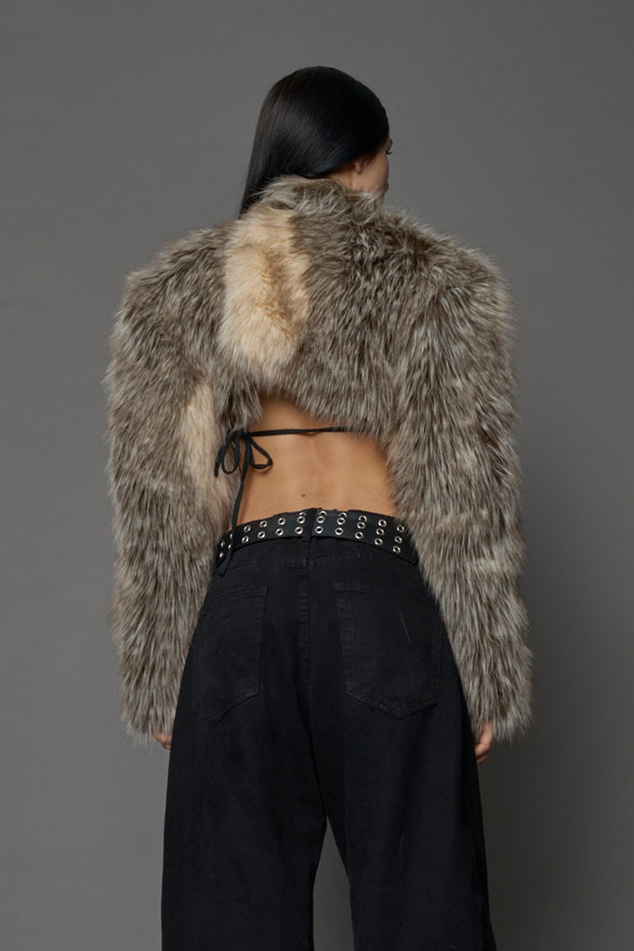 brown cropped faux fur jacket with exaggerated shoulders and high neck – bold statement outerwear for nightlife, streetwear, or runway looks.