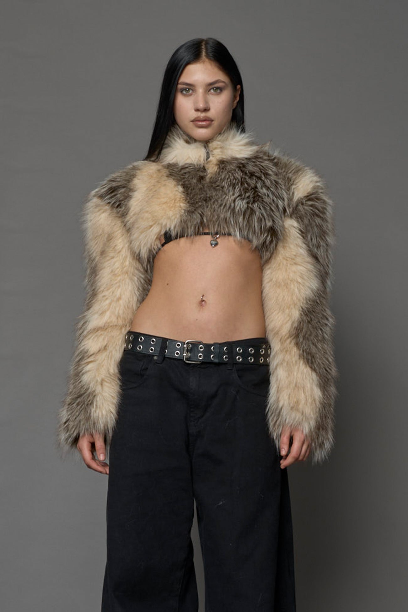 brown cropped faux fur jacket with exaggerated shoulders and high neck – bold statement outerwear for nightlife, streetwear, or runway looks.