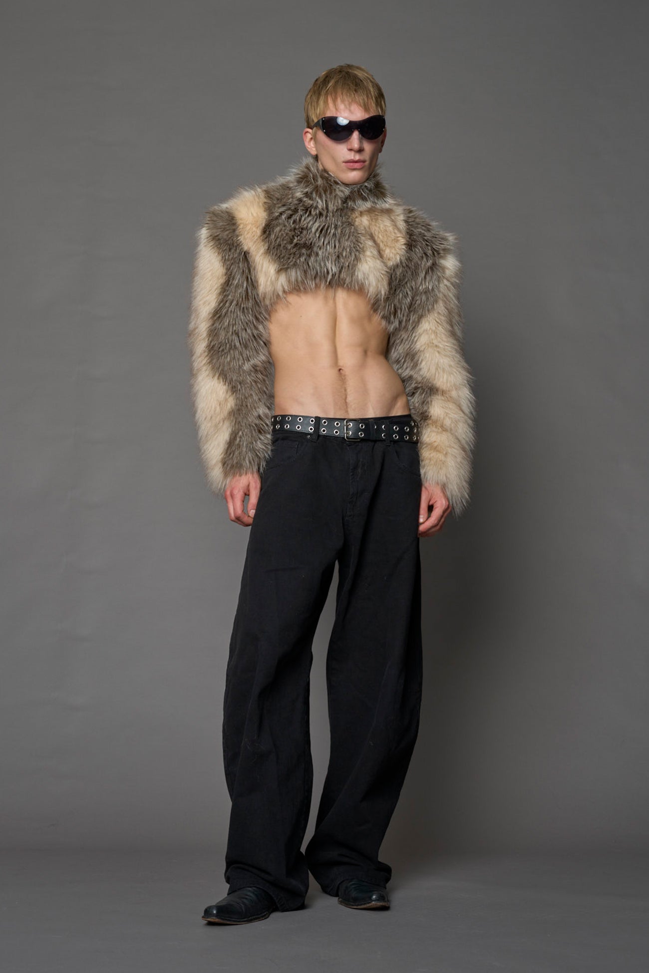 brown cropped faux fur jacket with exaggerated shoulders and high neck – bold statement outerwear for nightlife, streetwear, or runway looks.