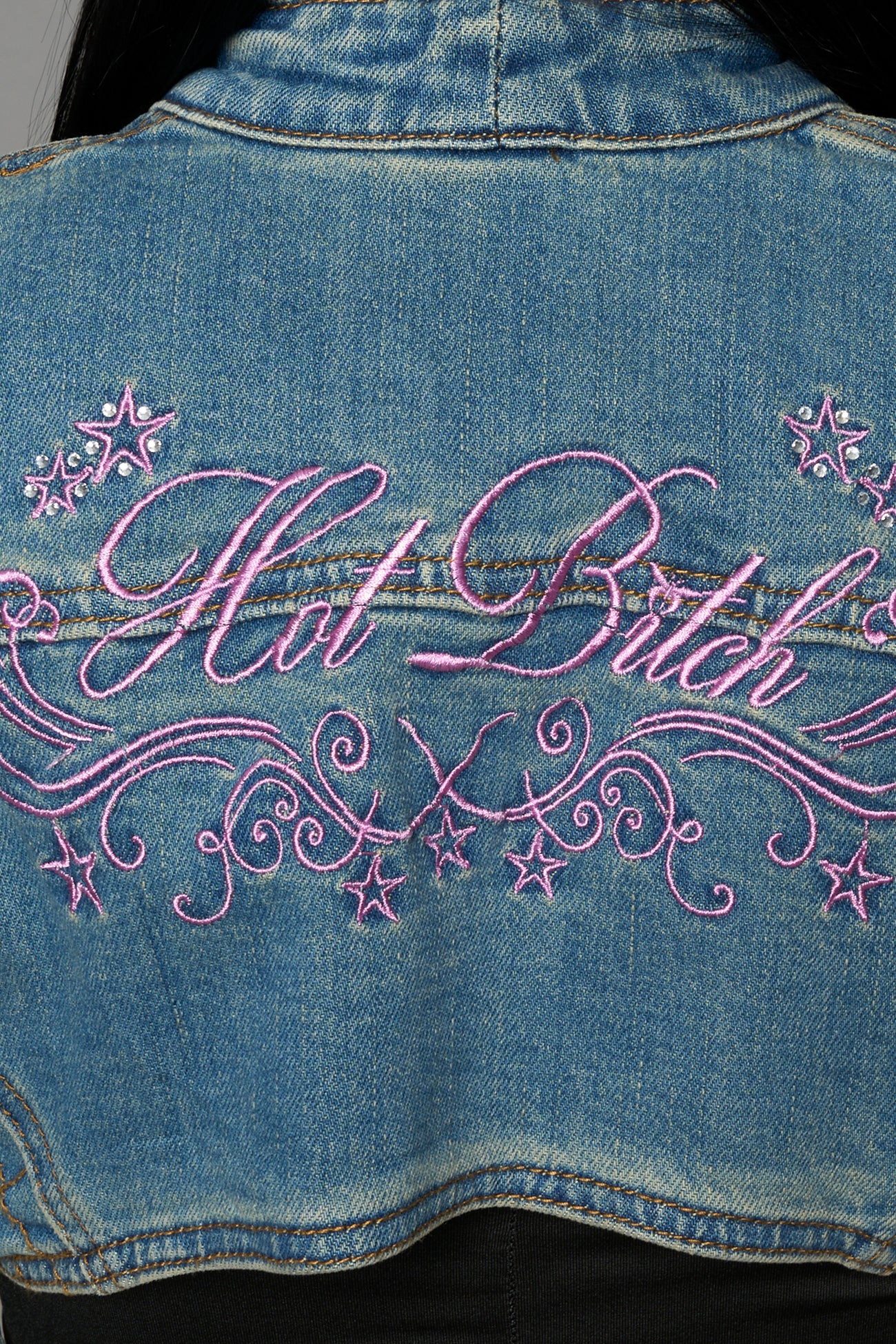 Namilia blue cropped denim bolero jacket with exaggerated shoulders and pink embroidery on back