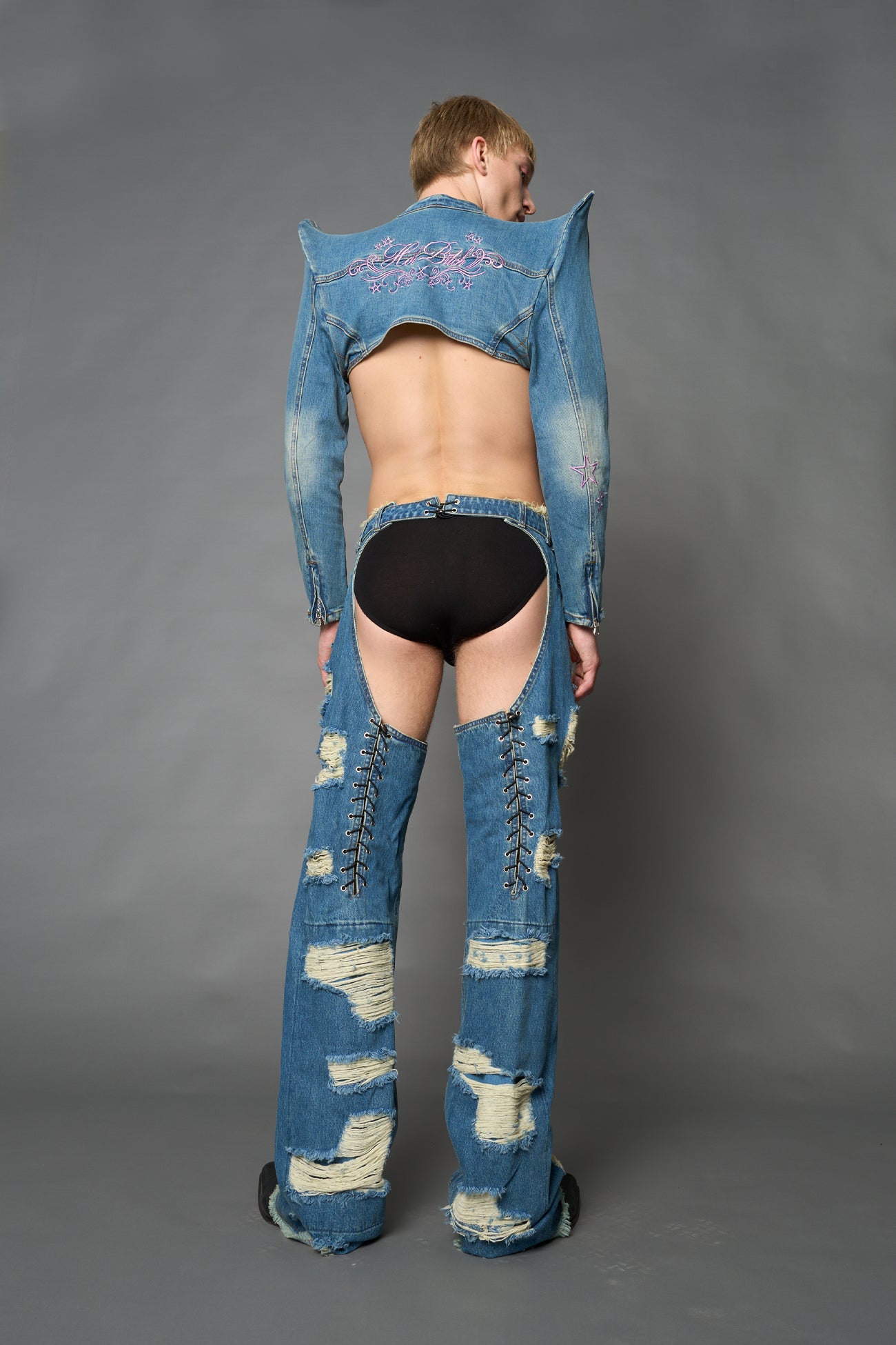 Namilia blue cropped denim bolero jacket with exaggerated shoulders and pink embroidery on back