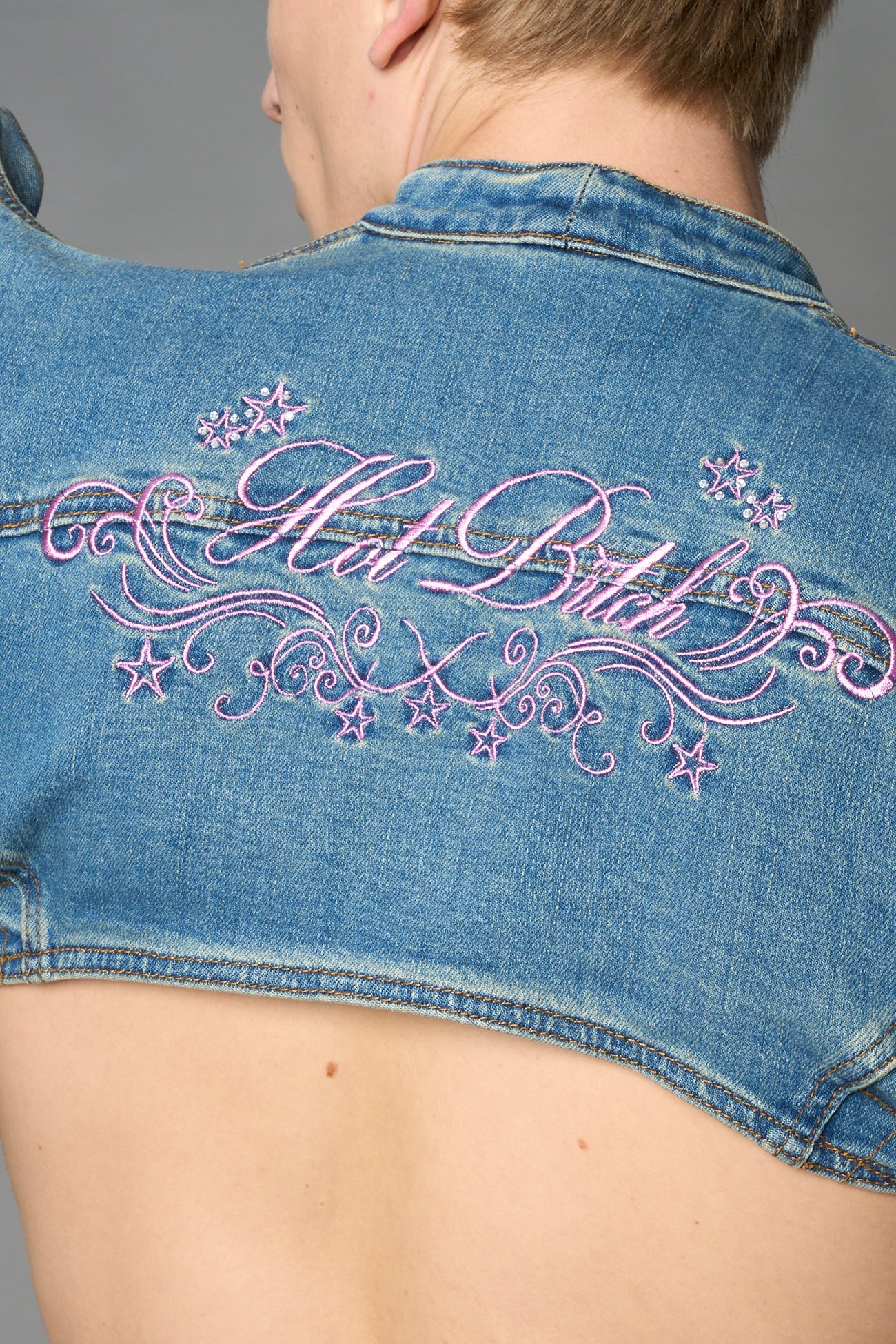 Namilia blue cropped denim bolero jacket with exaggerated shoulders and pink embroidery on back