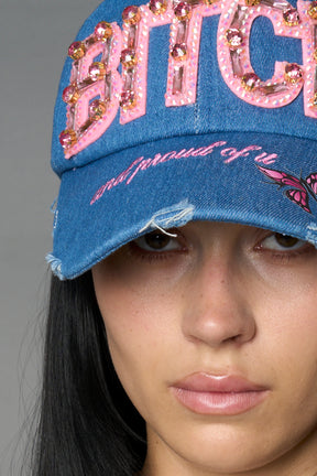 Blue denim baseball cap with pink rhinestone embroidery, butterfly graphic and distressed brim – Namilia