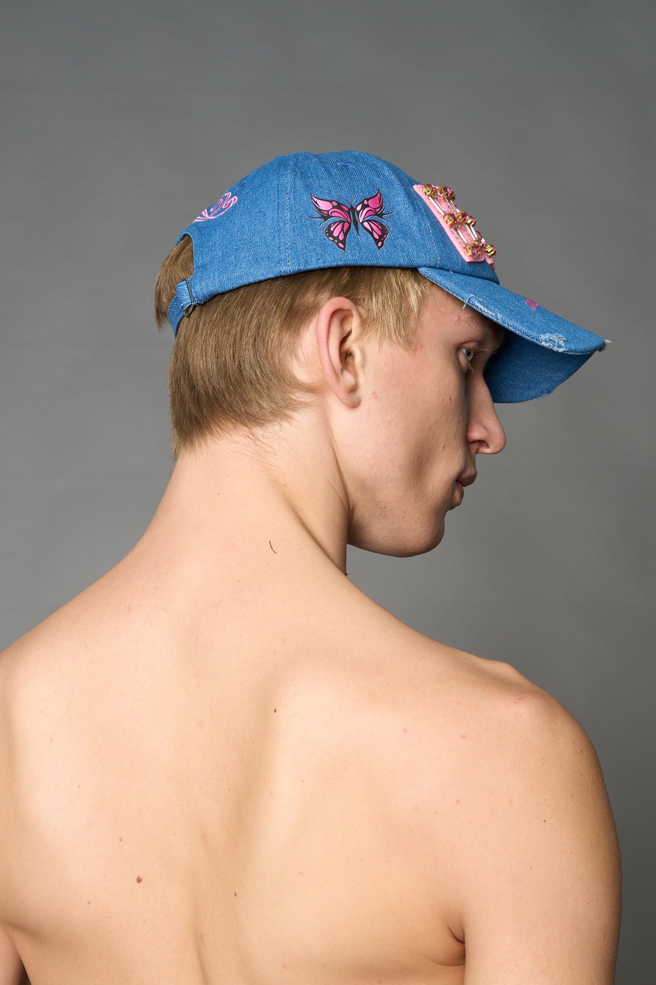 Blue denim baseball cap with pink rhinestone embroidery, butterfly graphic and distressed brim – Namilia