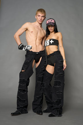 Namilia shredded black denim chaps with low-rise fit, extreme thigh cut-outs and distressed straight legs