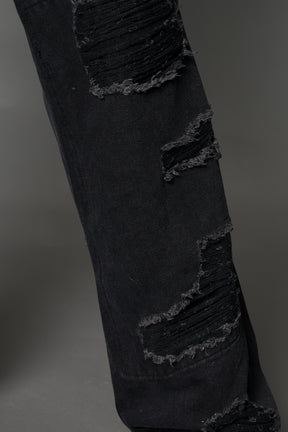 Namilia shredded black denim chaps with low-rise fit, extreme thigh cut-outs and distressed straight legs