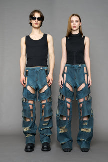 model wearing blue smoke denim pants with motocross inspired cut outs BLUE SMOKE
