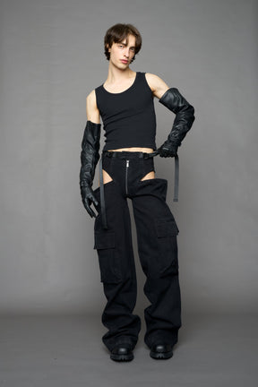 model wearing black dark washed denim trousers with cut out design and 3D pockets