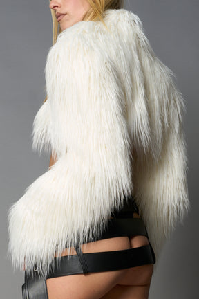 white cropped faux fur jacket with exaggerated shoulders and high neck – bold statement outerwear for nightlife, streetwear, or runway looks.