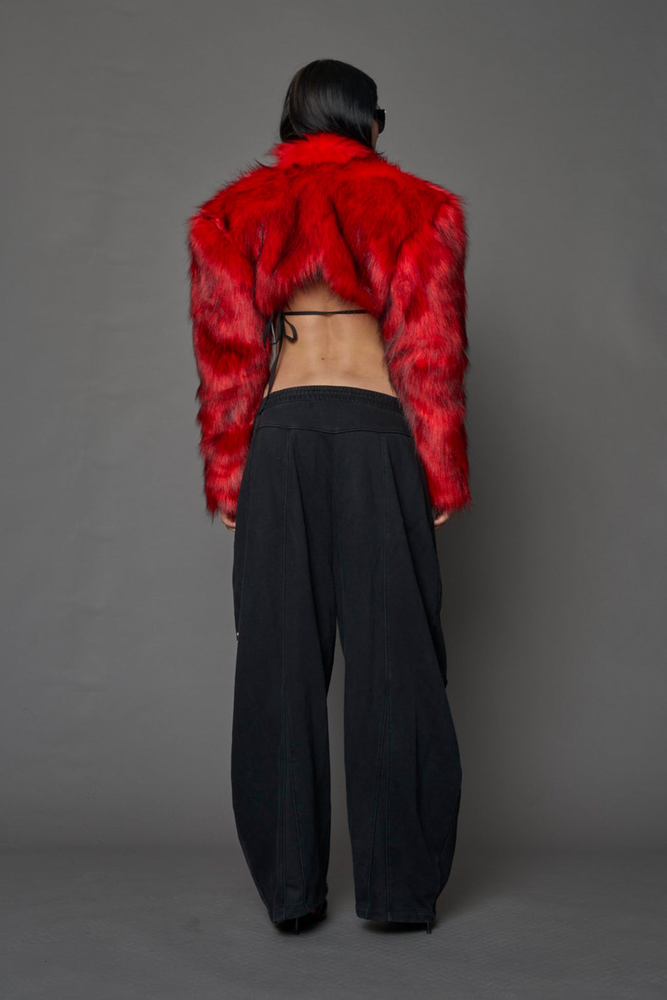 red cropped faux fur jacket with exaggerated shoulders and high neck – bold statement outerwear for nightlife, streetwear, or runway looks.