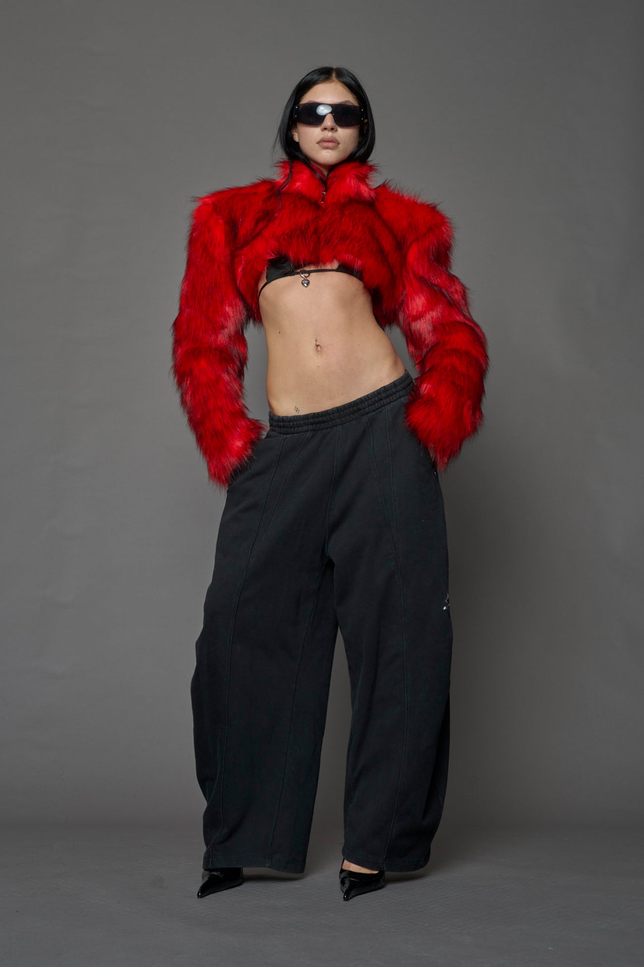 red cropped faux fur jacket with exaggerated shoulders and high neck – bold statement outerwear for nightlife, streetwear, or runway looks.