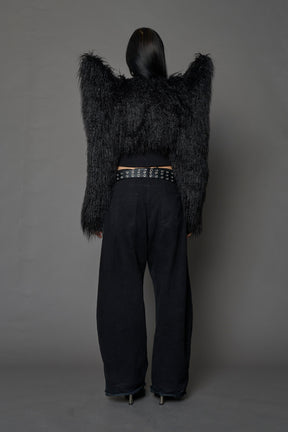 Model wearing black spike shoulder crop faux fur coat