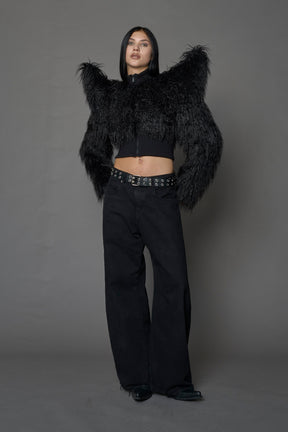 Model wearing black spike shoulder crop faux fur coat