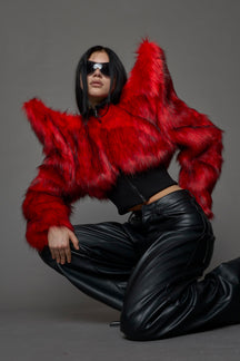 Model wearing red spike shoulder crop faux fur coat