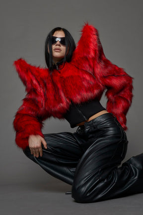 Model wearing red spike shoulder crop faux fur coat