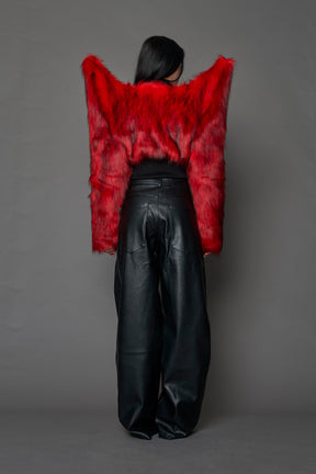 Model wearing red spike shoulder crop faux fur coat