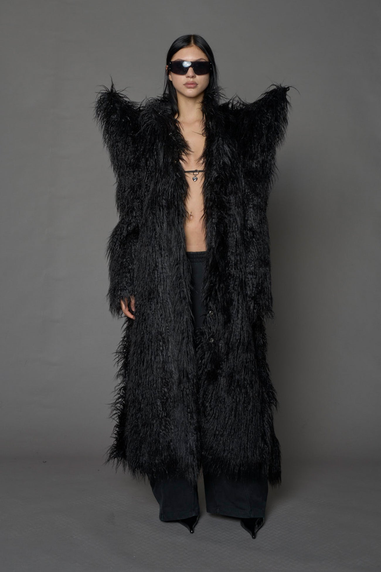 model wearing black spike shoulder long faux fur coat