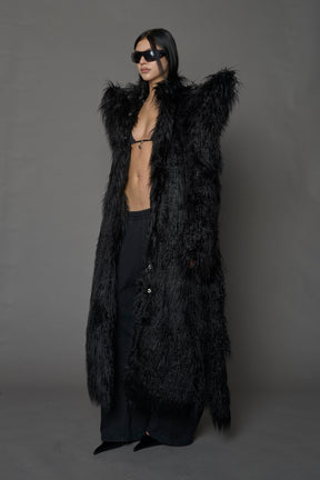 model wearing black spike shoulder long faux fur coat