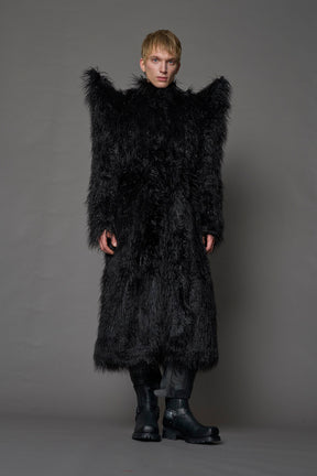 model wearing black spike shoulder long faux fur coat