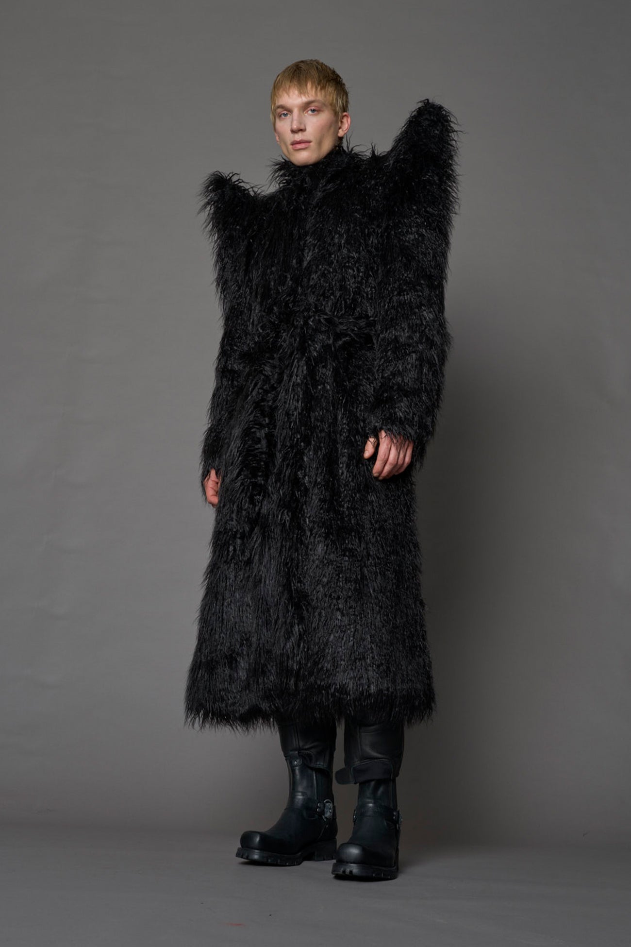model wearing black spike shoulder long faux fur coat