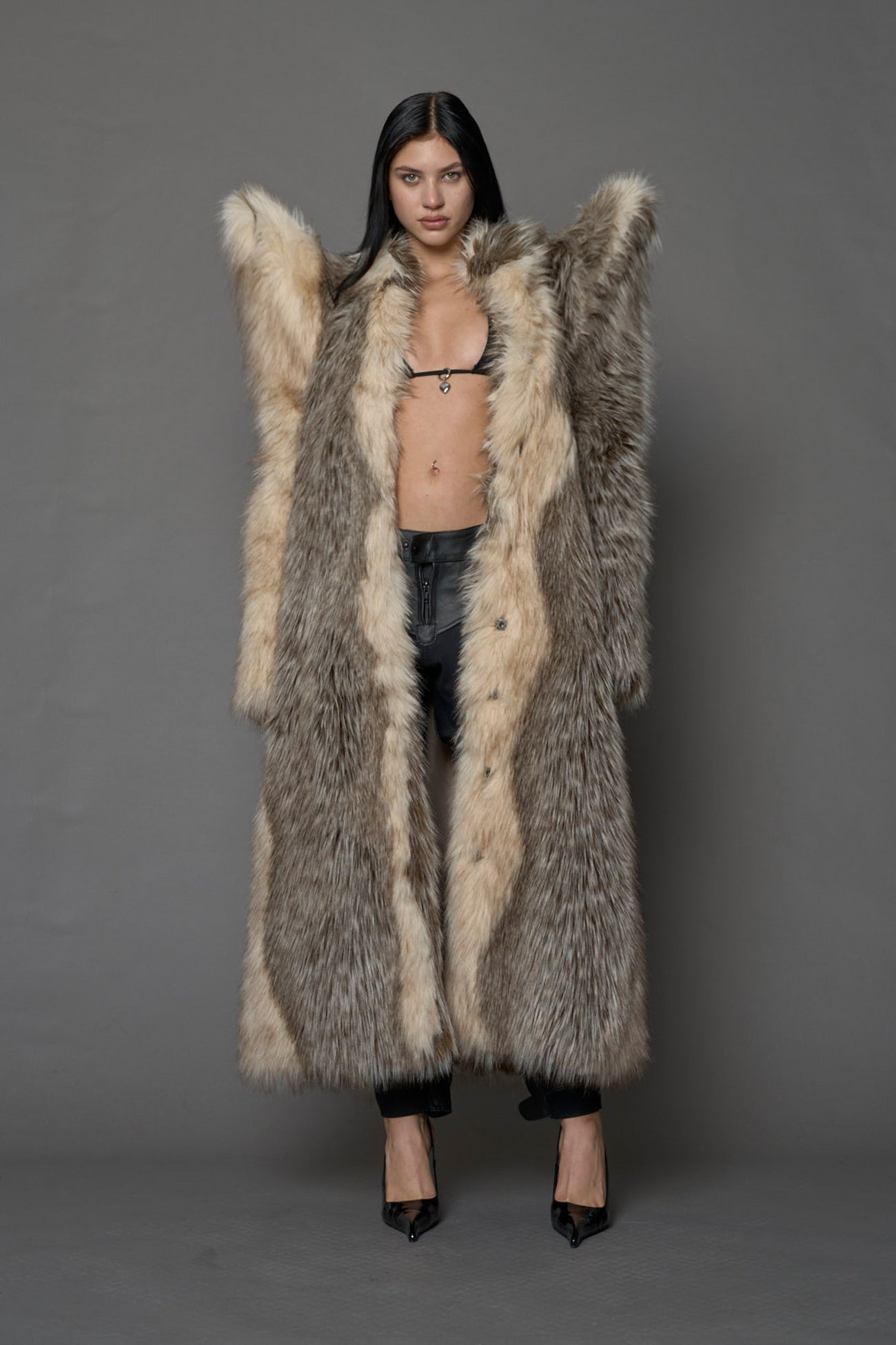 model wearing brown spike shoulder long faux fur coat