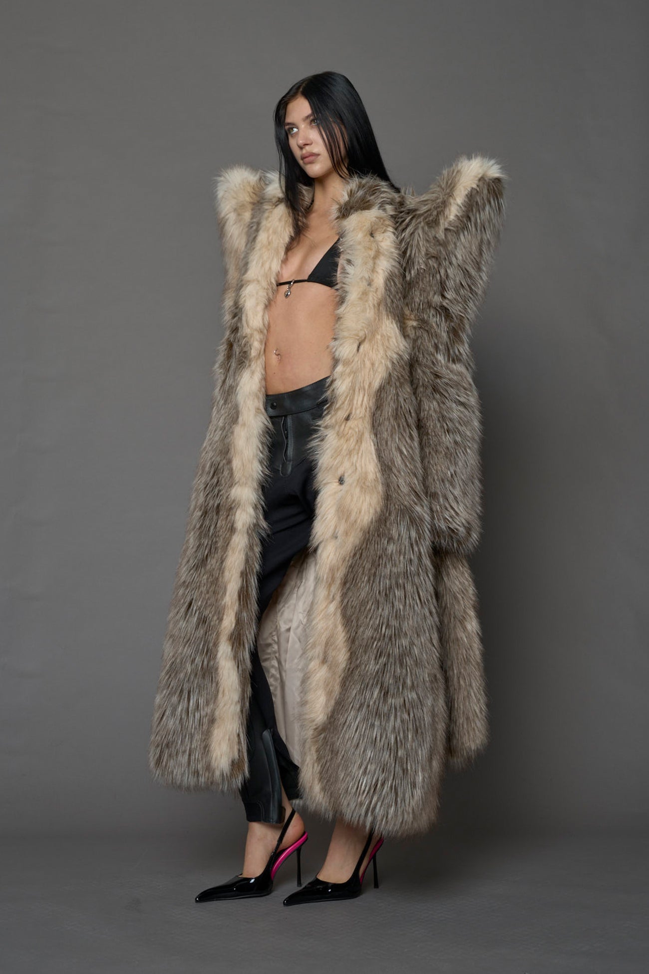 model wearing brown spike shoulder long faux fur coat