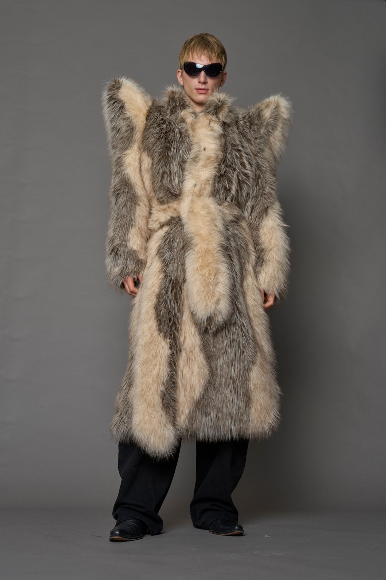 model wearing brown spike shoulder long faux fur coat