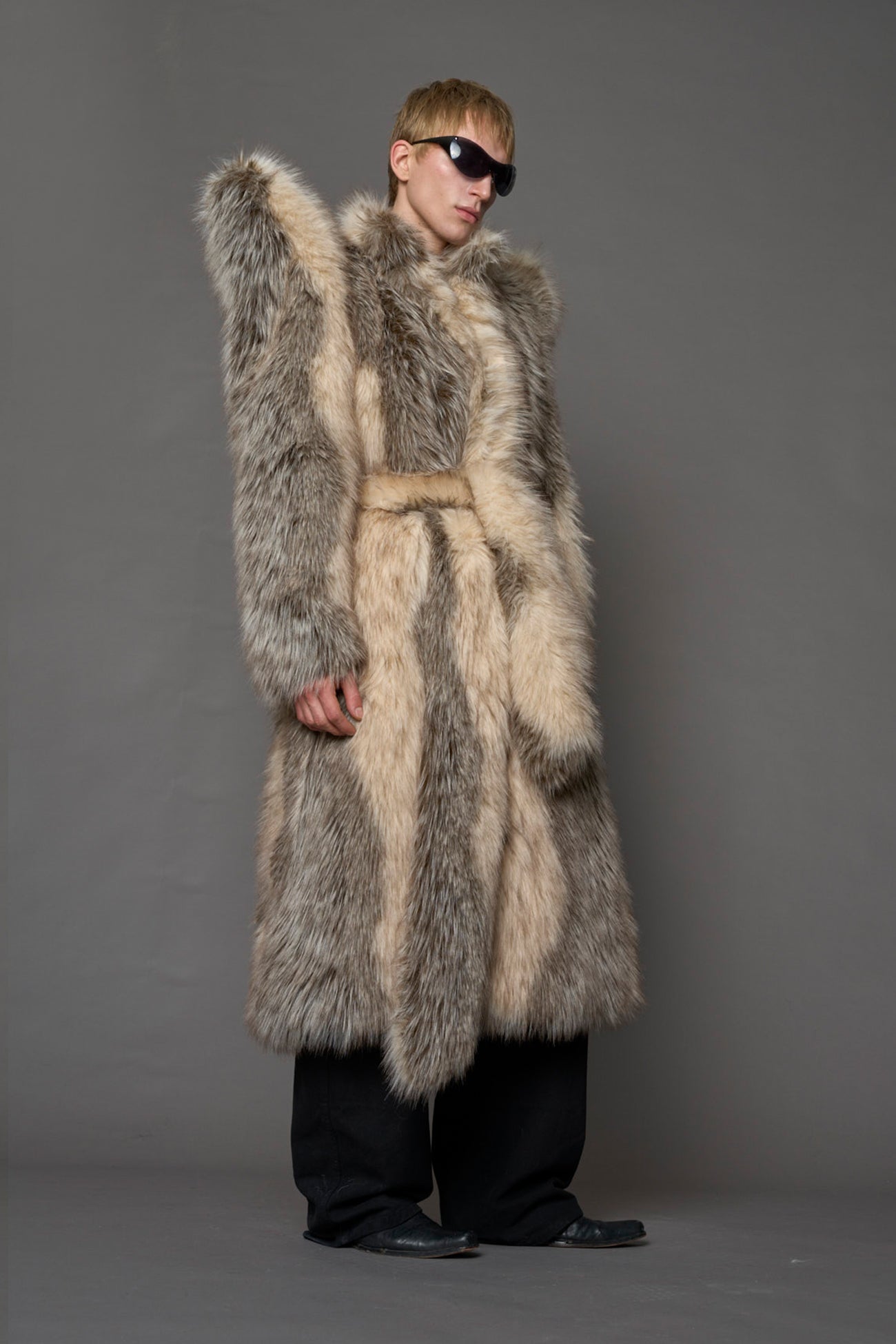model wearing brown spike shoulder long faux fur coat