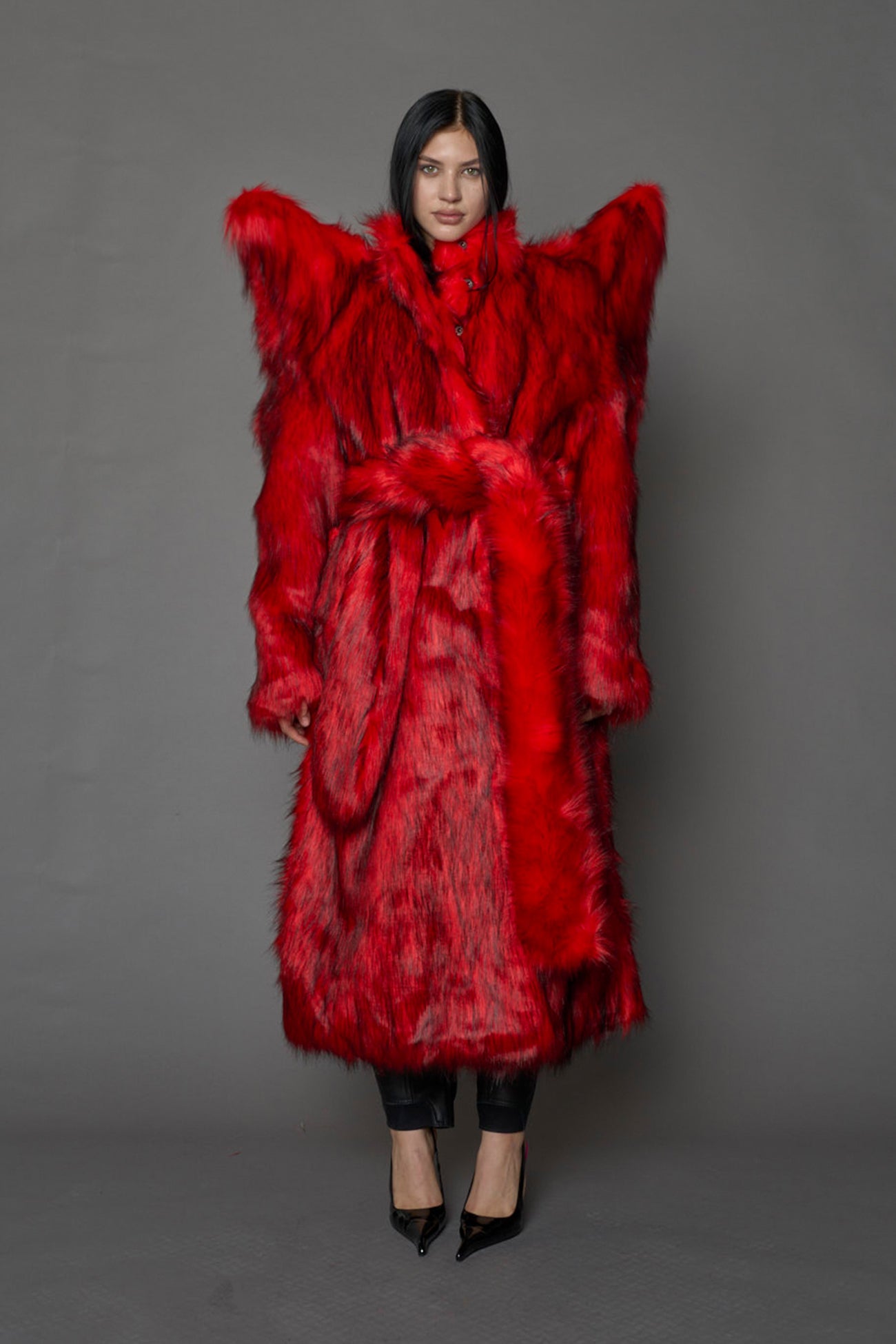 model wearing red spike shoulder long faux fur coat