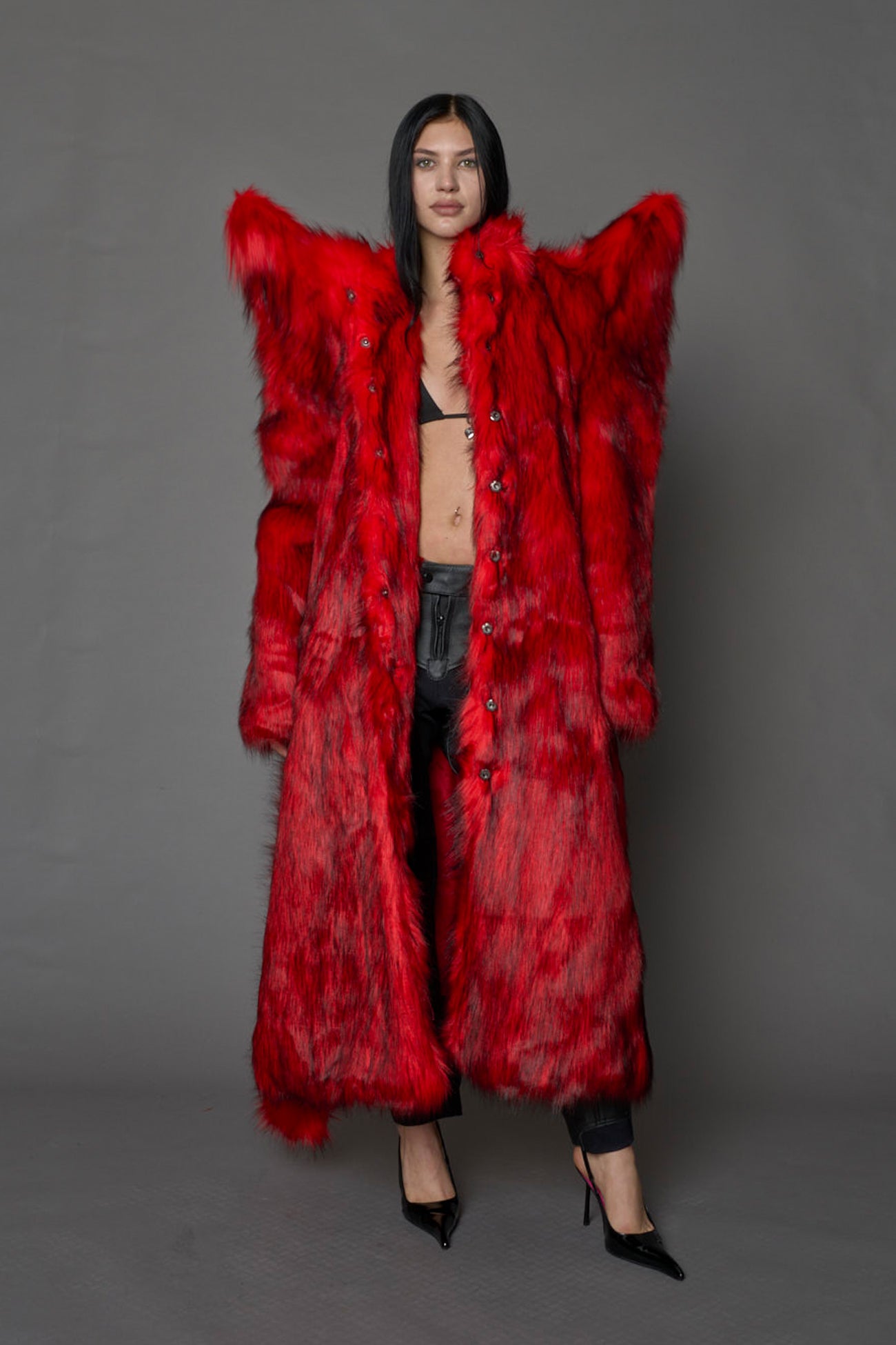 model wearing red spike shoulder long faux fur coat