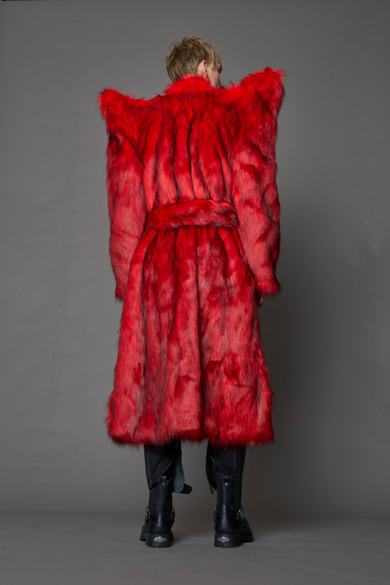 model wearing red spike shoulder long faux fur coat